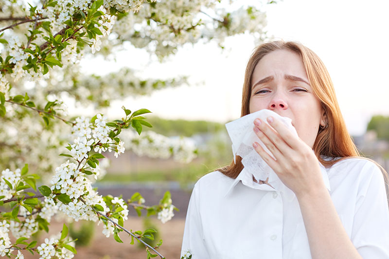 Girl sneezing for nasal allergic symptoms
