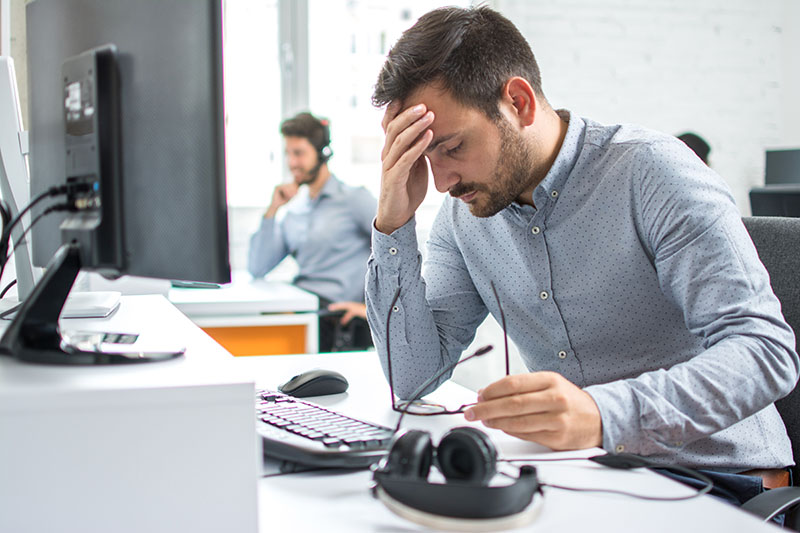 Man in office with burden symptoms